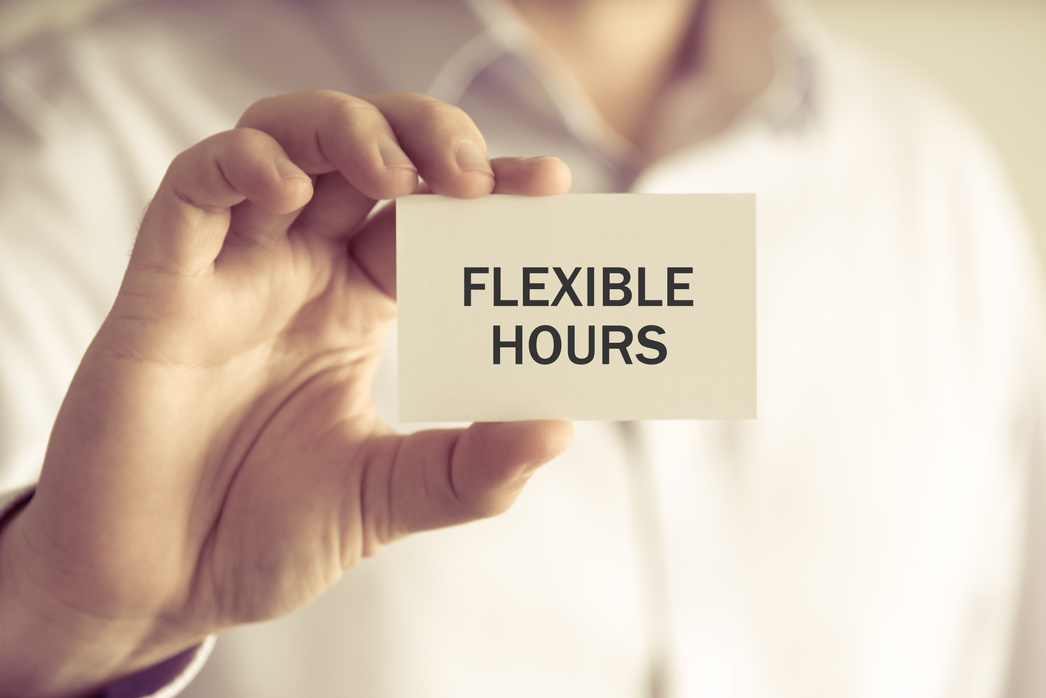 Businessman holding FLEXIBLE HOURS message card